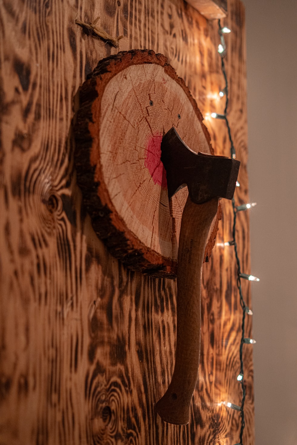 Axe stuck in a wooden target board
