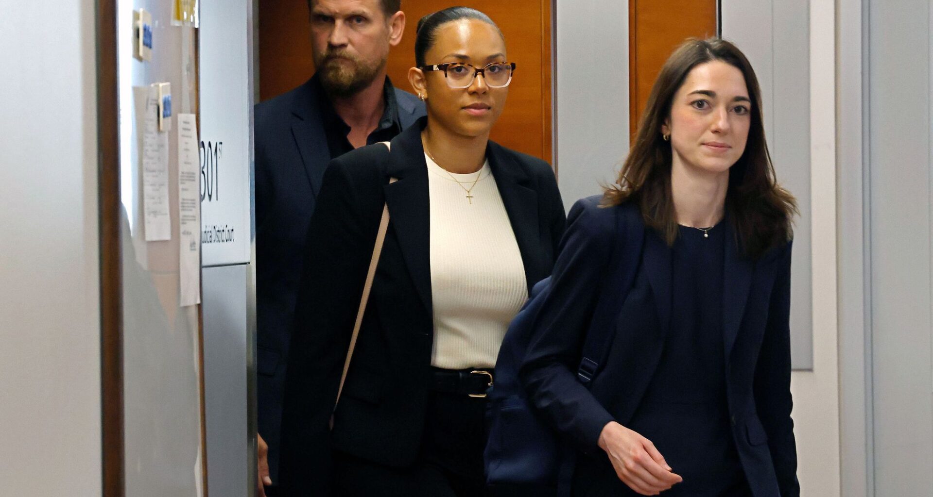 McKenna West, center, comes out of a courtroom with her legal team after a hearing regarding her baby surrogacy case on Tuesday, Aug. 25, 2026, in Dallas.