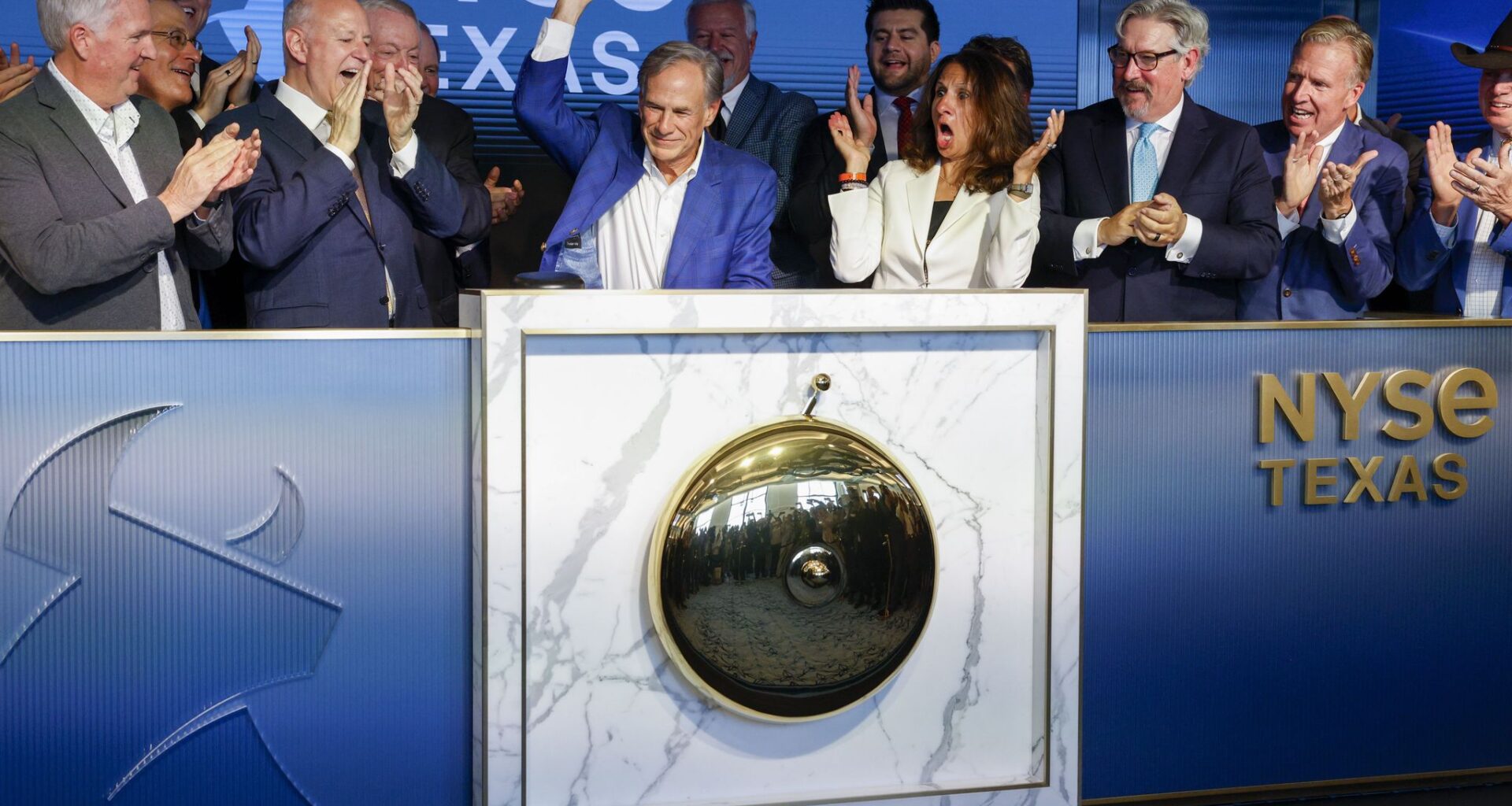 Gov. Greg Abbott rings the closing bell of the New York Stock Exchange as NYSE CEO Lynn Martin (center) reacts alongside NYSE President Bryan Daniel (second from right) during an event unveiling the NYSE Texas offices at Old Parkland on Thursday, Aug. 27, 2026, in Dallas.