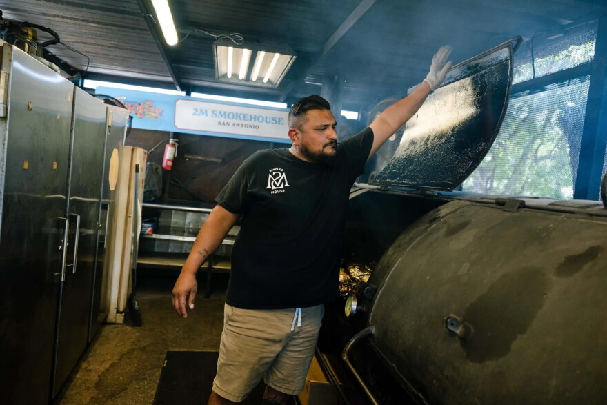 Pitmaster Esaul Ramos is seen smoking brisket at his San Antonio BBQ joint 2M Smokehouse on May 29, 2025.