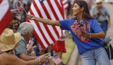 Nichole Aguirre gives her service dog "Trip" a drink of water after a long DART train ride to the Texas State Fair on Friday, Sept. 26, 2025, in Dallas.