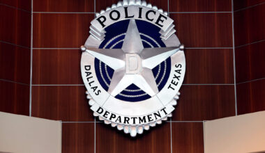 Dallas Police say a sports car struck an SUV, a parked vehicle and a tree in downtown Dallas, sending four people to a hospital. Police arrested the driver on a DWI charge.