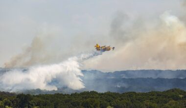 A 'Super Scooper' plane drops water on the Ross fire spreading across the ridge, on Friday, Aug. 28, 2026 in Palo Pinto County.