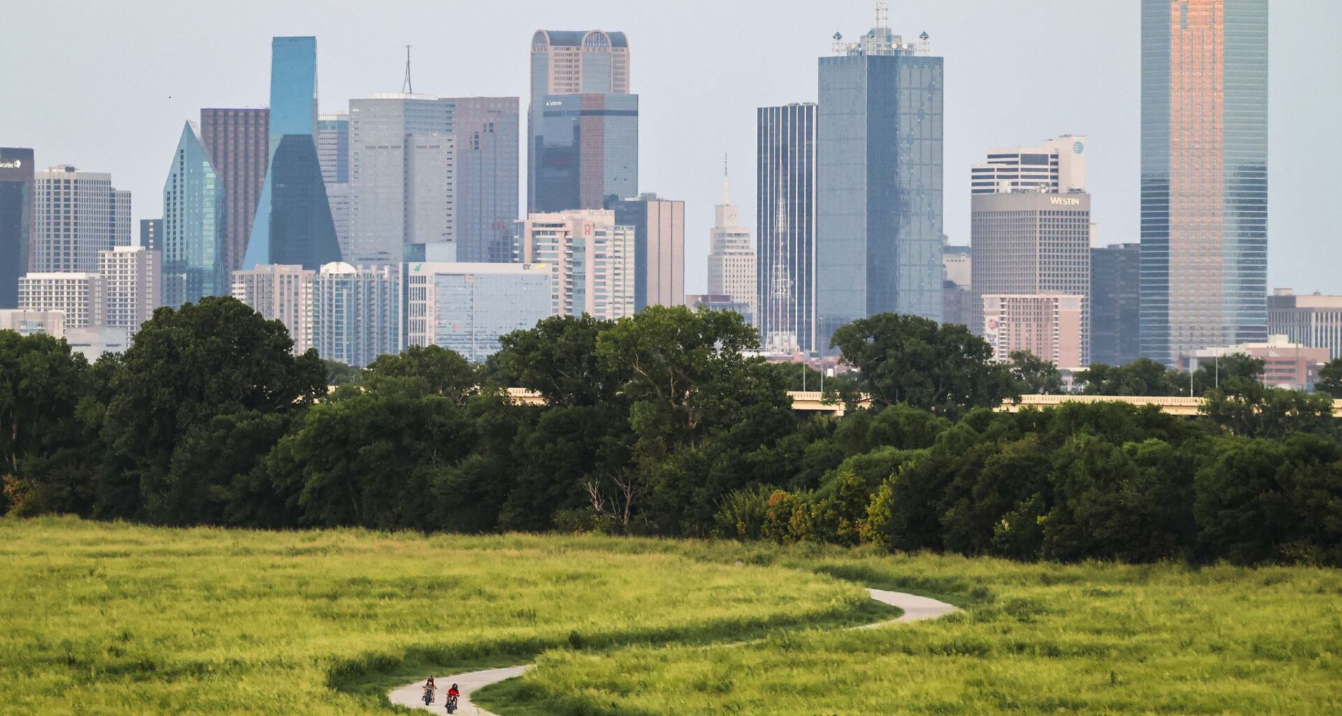Bicyclists pass along the Trinity Skyline Trail during a warm summer day, on Wednesday, July 29, 2026 in Dallas.