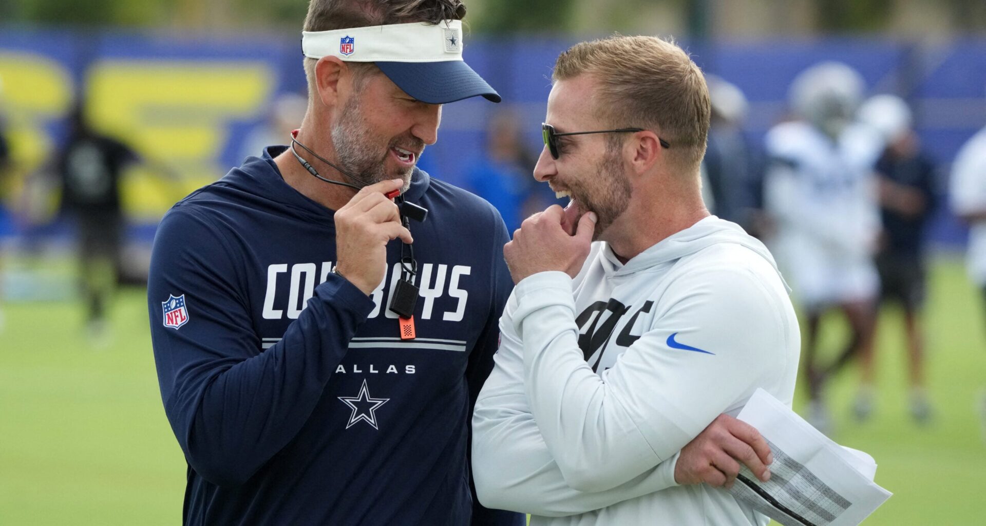 Aug 11, 2026; Woodland Hills, CA, USA; Dallas Cowboys head coach Brian Schottenheimer (left) and Los Angeles Rams head coach Sean McVay react during a joint practice at the Rams Practice Facility.