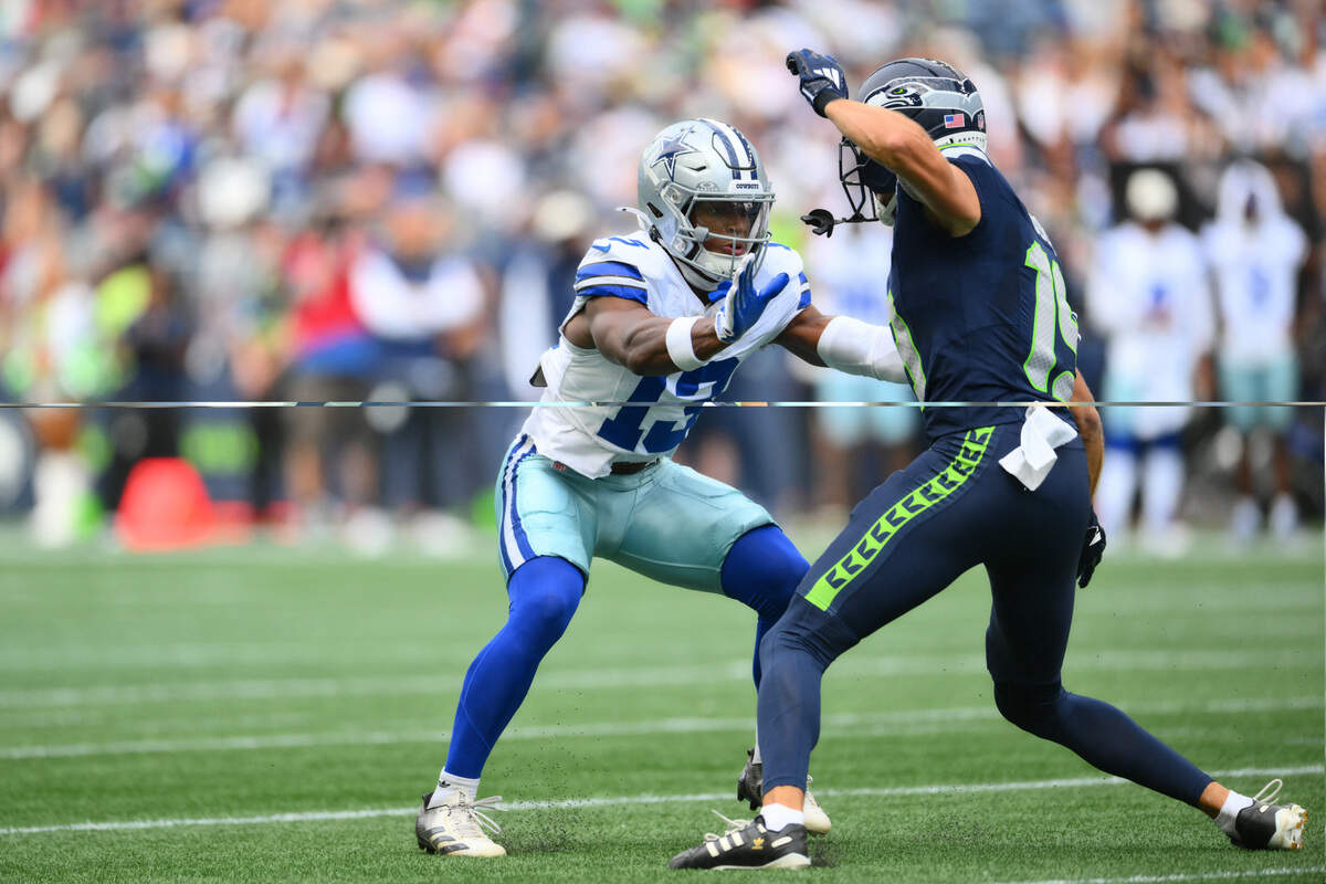 Dallas Cowboys safety Caleb Downs (left) covers Seattle Seahawks wide receiver Jake Bobo during the first half of a preseason game Saturday at Lumen Field in Seattle.
