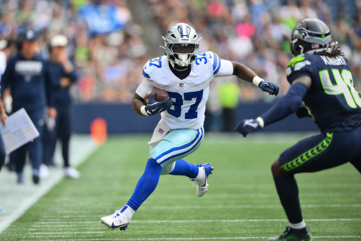 Dallas Cowboys running back Phil Mafah (37) carries the ball after a catch during the first half of a preseason game against the Seattle Seahawks on Saturday at Lumen Field in Seattle.