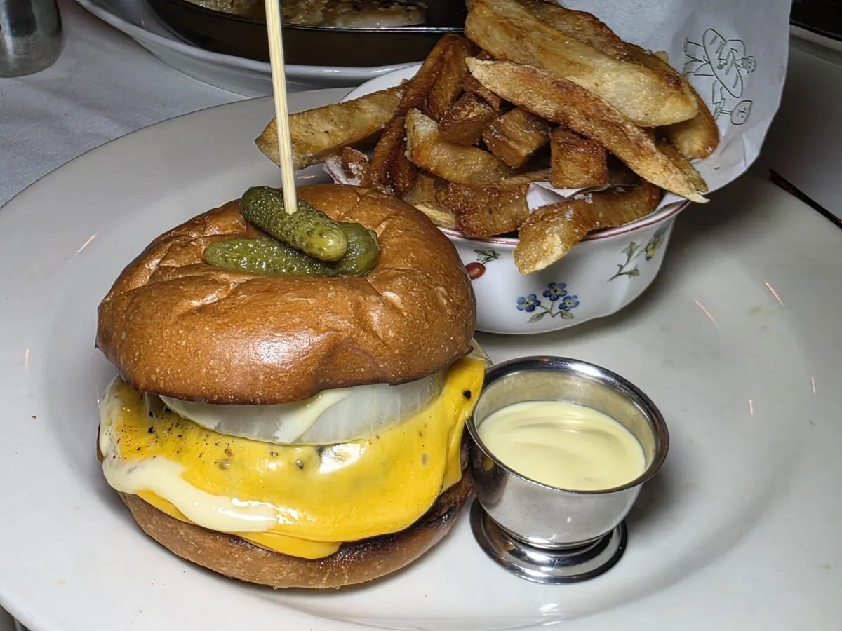The luxurious dry-aged burger is not for the faint of heart, nor parsimonious. The accompanying fries are a delight, lightly browned and crisp all over the exterior while remaining hot and fluffy inside. Photo by Mario-Sebastian Berry.