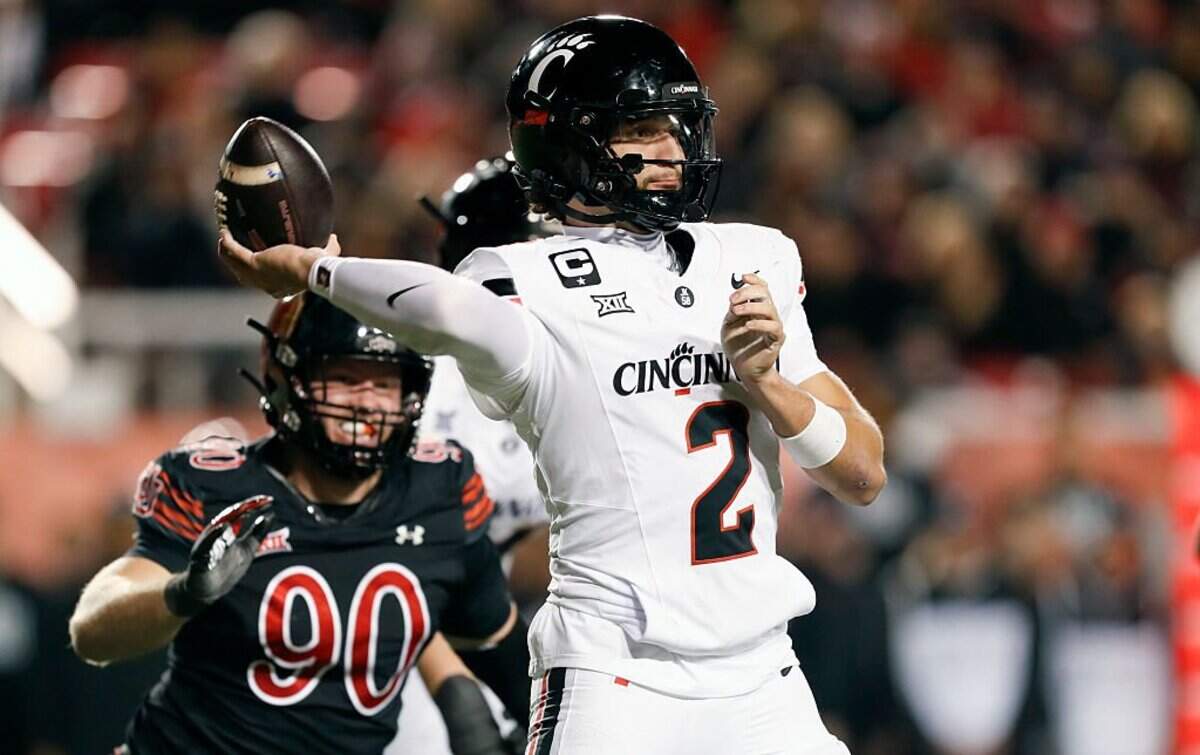 SALT LAKE CITY, UT - NOVEMBER 1: Brendan Sorsby #2 of the Cincinnati Bearcats throws a pass under pressure from John Henry Daley #90 of the Utah Utes during the second half of their game at Rice-Eccles Stadium on November 1, 2025 in Salt Lake City, Utah. (Photo by Chris Gardner/Getty Images)