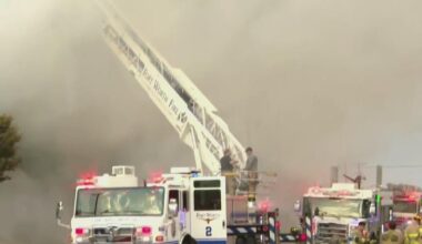 Residents pulled from apartment building as firefighters battle fire, officials say