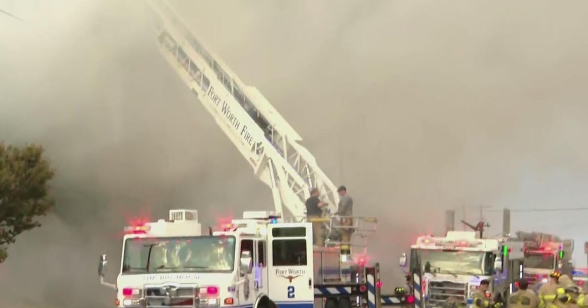 Residents pulled from apartment building as firefighters battle fire, officials say