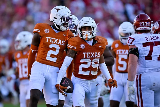 Oct 11, 2025; Dallas, Texas, USA; Texas Longhorns defensive back Derek Williams Jr. (2) and defensive back Graceson Littleton (29) celebrate after Littleton intercepts a pass from Oklahoma Sooners quarterback John Mateer (not pictured) during the second half at the Cotton Bowl. Mandatory Credit: Jerome Miron-Imagn Images