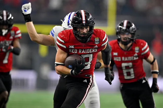 Dec 6, 2025; Arlington, TX, USA; Texas Tech Red Raiders linebacker Ben Roberts (13) returns an interception against the BYU Cougars during the second half at AT & T Stadium. Mandatory Credit: Jerome Miron-Imagn Images