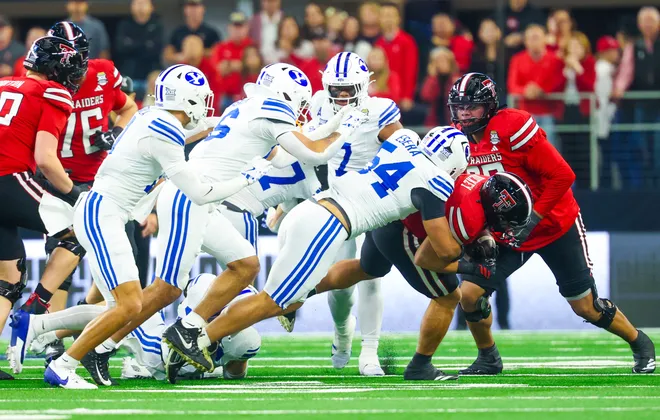 Dec 6, 2025; Arlington, TX, USA; BYU Cougars linebacker Siale Esera (54) tackles Texas Tech Red Raiders running back Cameron Dickey (8) during the first quarter at AT & T Stadium. Mandatory Credit: Kevin Jairaj-Imagn Images