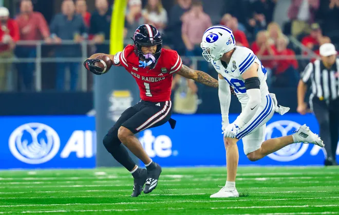 Dec 6, 2025; Arlington, TX, USA; Texas Tech Red Raiders wide receiver Reggie Virgil (1) runs with the ball as BYU Cougars safety Tanner Wall (28) defends during the first half at AT & T Stadium. Mandatory Credit: Kevin Jairaj-Imagn Images