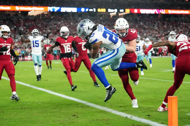 Dallas Cowboys running back Malik Davis (20) scores for a touchdown against the Arizona Cardinals during the first half at State Farm Stadium. Mandatory Credit: Joe Camporeale-Imagn Images