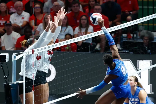 Aug 27, 2026; Arlington, TX, USA; Florida Gators outside hitter Aniya Madkin (9) attacks the ball against the Nebraska Cornhuskers during their volleyball match at AT & T Stadium. Mandatory Credit: Chris Jones-Imagn Images