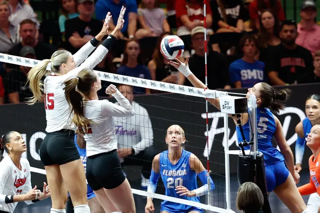 Aug 27, 2026; Arlington, TX, USA; Nebraska Cornhuskers players attempt to block an attack by Florida Gators outside hitter Selena Leban (5) during their volleyball match at AT & T Stadium. Mandatory Credit: Chris Jones-Imagn Images
