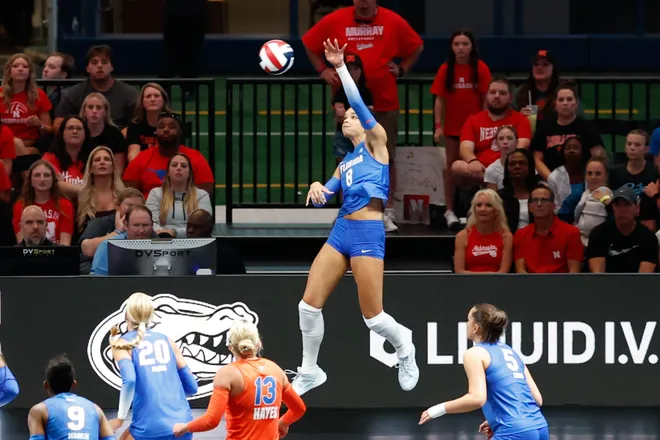 Aug 27, 2026; Arlington, TX, USA; Florida Gators opposite Logan King (8) attacks the ball against the Nebraska Cornhuskers during their volleyball match at AT & T Stadium. Mandatory Credit: Chris Jones-Imagn Images