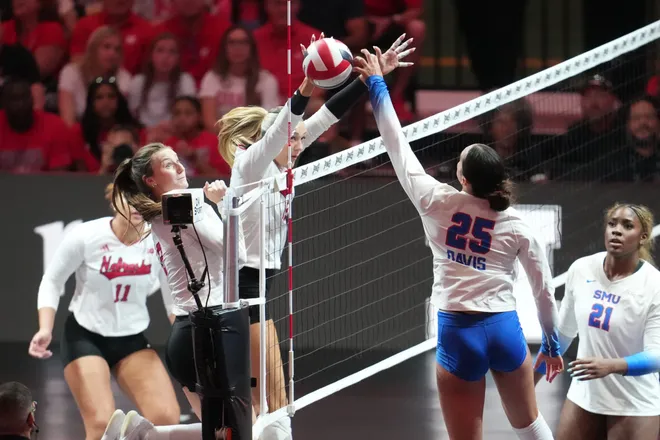 Aug 28, 2026; Arlington, TX, USA; SMU Mustangs outside hitter Suli Davis (25) attacks the ball against Nebraska Cornhuskers middle blocker Andi Jackson (15) during their volleyball match at AT & T Stadium. Mandatory Credit: Chris Jones-Imagn Images