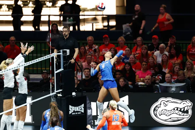 Aug 27, 2026; Arlington, TX, USA; Florida Gators opposite Logan King (8) attacks the ball against the Nebraska Cornhuskers during their volleyball match at AT & T Stadium. Mandatory Credit: Chris Jones-Imagn Images