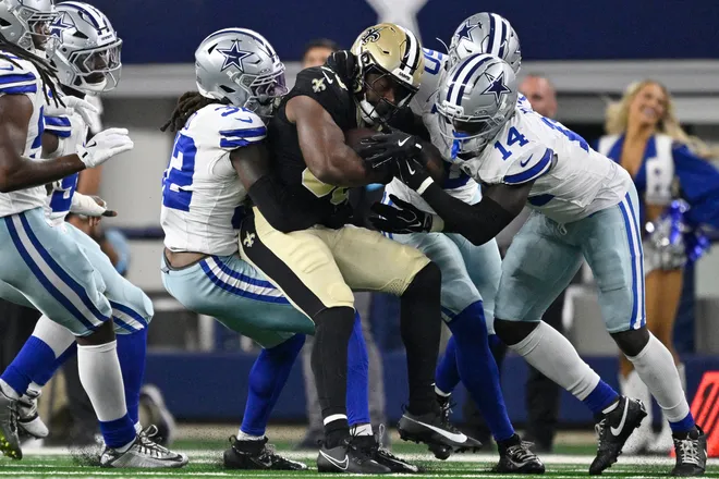 Aug 28, 2026; Arlington, Texas, USA; Dallas Cowboys safety Julius Wood (32) and safety Markquese Bell (14) tackle New Orleans Saints running back Audric Estime (30) during the first quarter at AT & T Stadium. Mandatory Credit: Jerome Miron-Imagn Images