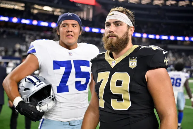 Aug 28, 2026; Arlington, Texas, USA; New Orleans Saints offensive line Alex Wollschlaeger (79) and Dallas Cowboys offensive line Shiyazh Pete (75) look on after the game at AT & T Stadium. Mandatory Credit: Jerome Miron-Imagn Images