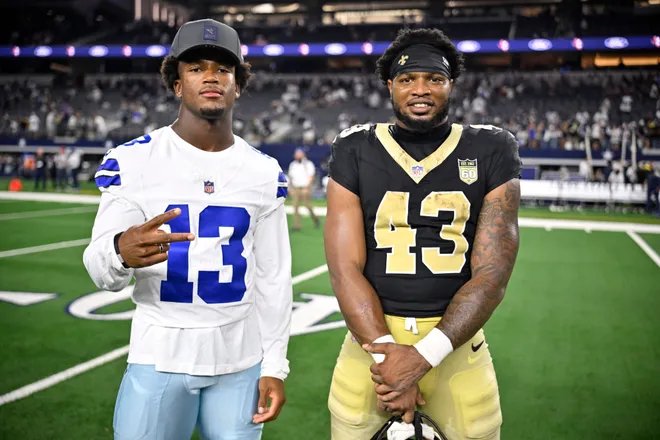 Aug 28, 2026; Arlington, Texas, USA; Dallas Cowboys safety Caleb Downs (13) and New Orleans Saints running back CJ Donaldson (43) pose after the game at AT & T Stadium. Mandatory Credit: Jerome Miron-Imagn Images