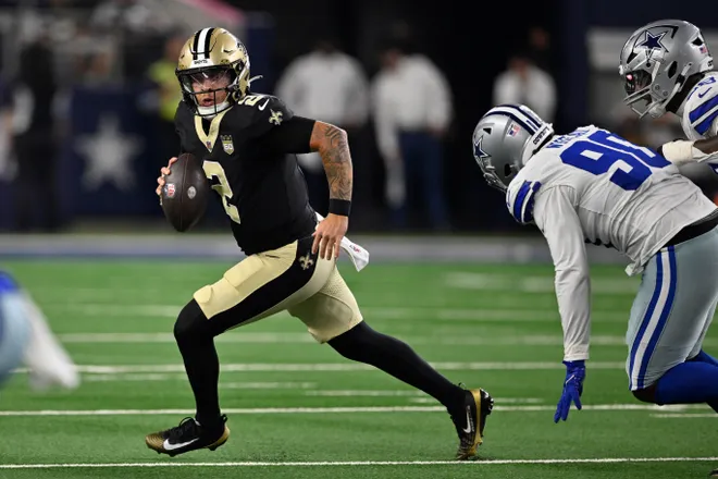 Aug 28, 2026; Arlington, Texas, USA; New Orleans Saints quarterback Spencer Rattler (2) runs against the Dallas Cowboys during the second quarter at AT & T Stadium. Mandatory Credit: Jerome Miron-Imagn Images