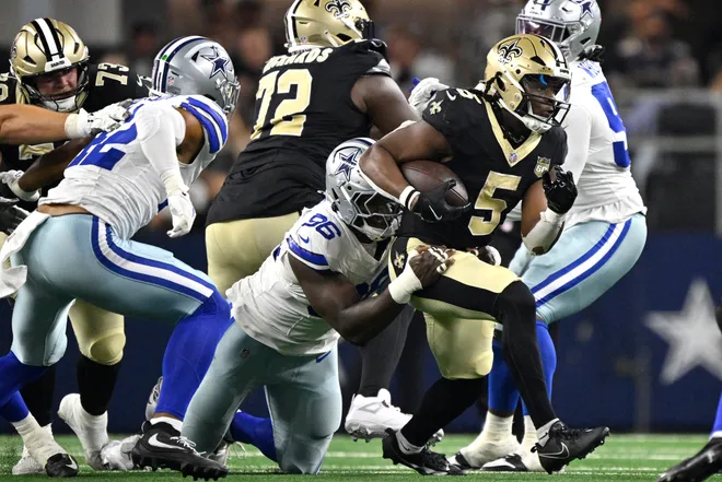 Aug 28, 2026; Arlington, Texas, USA; Dallas Cowboys defensive tackle Adedayo Odeleye (96) tackles New Orleans Saints running back Kendre Miller (5) during the first half at AT & T Stadium. Mandatory Credit: Jerome Miron-Imagn Images
