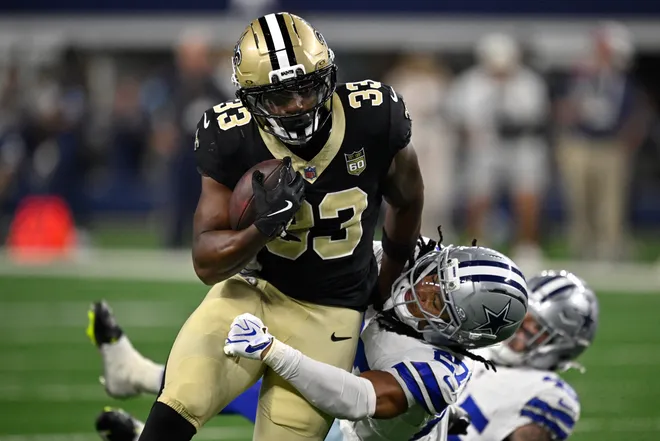 Aug 28, 2026; Arlington, Texas, USA; New Orleans Saints running back Zamir White (33) runs against Dallas Cowboys cornerback Reddy Steward (27) during the third quarter at AT & T Stadium. Mandatory Credit: Jerome Miron-Imagn Images