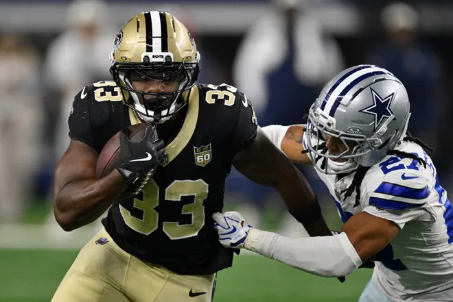 Aug 28, 2026; Arlington, Texas, USA; New Orleans Saints running back Zamir White (33) runs against Dallas Cowboys cornerback Reddy Steward (27) during the third quarter at AT & T Stadium. Mandatory Credit: Jerome Miron-Imagn Images