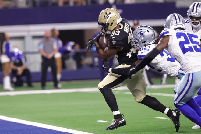Aug 28, 2026; Arlington, Texas, USA; New Orleans Saints running back Zamir White (33) runs to score a touchdown against Dallas Cowboys safety Julius Wood (32) during the third quarter at AT & T Stadium. Mandatory Credit: Kevin Jairaj-Imagn Images