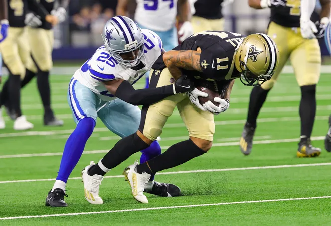 Aug 28, 2026; Arlington, Texas, USA; New Orleans Saints wide receiver Ronnie Bell (11) runs with the ball as Dallas Cowboys cornerback Trikweze Bridges (25) defends during the second half at AT & T Stadium. Mandatory Credit: Kevin Jairaj-Imagn Images