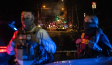 Federal agents stood near the scene where an ICE officer shot a man from Venezuela while trying to detain him in January, 2026.