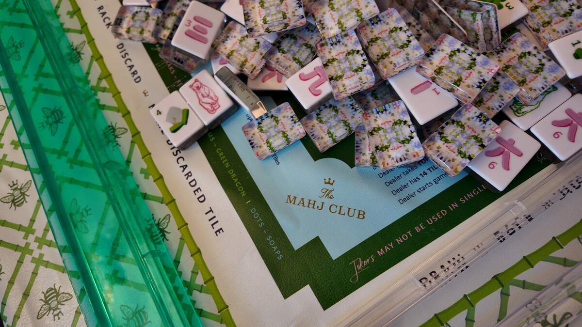 The Mahj Clubhouse features custom mats and tiles crested with The Mahj Club name. The post-COVID trend of voguish mahjong sets helped propel the game to popularity in North Texas.