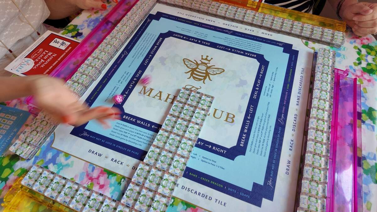 To determine the dealer, a player at The Mahj Clubhouse in Fort Worth rolls the pink dice at the beginning of the mahjong match.