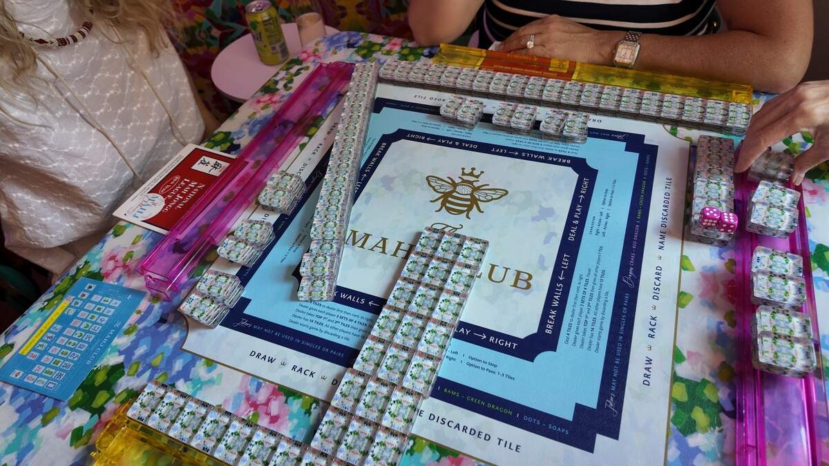 A mahjong match begins at The Mahj Clubhouse in Fort Worth atop their custom mats and tiles created by owner Amanda Wolsey and artist Emily Nichols.