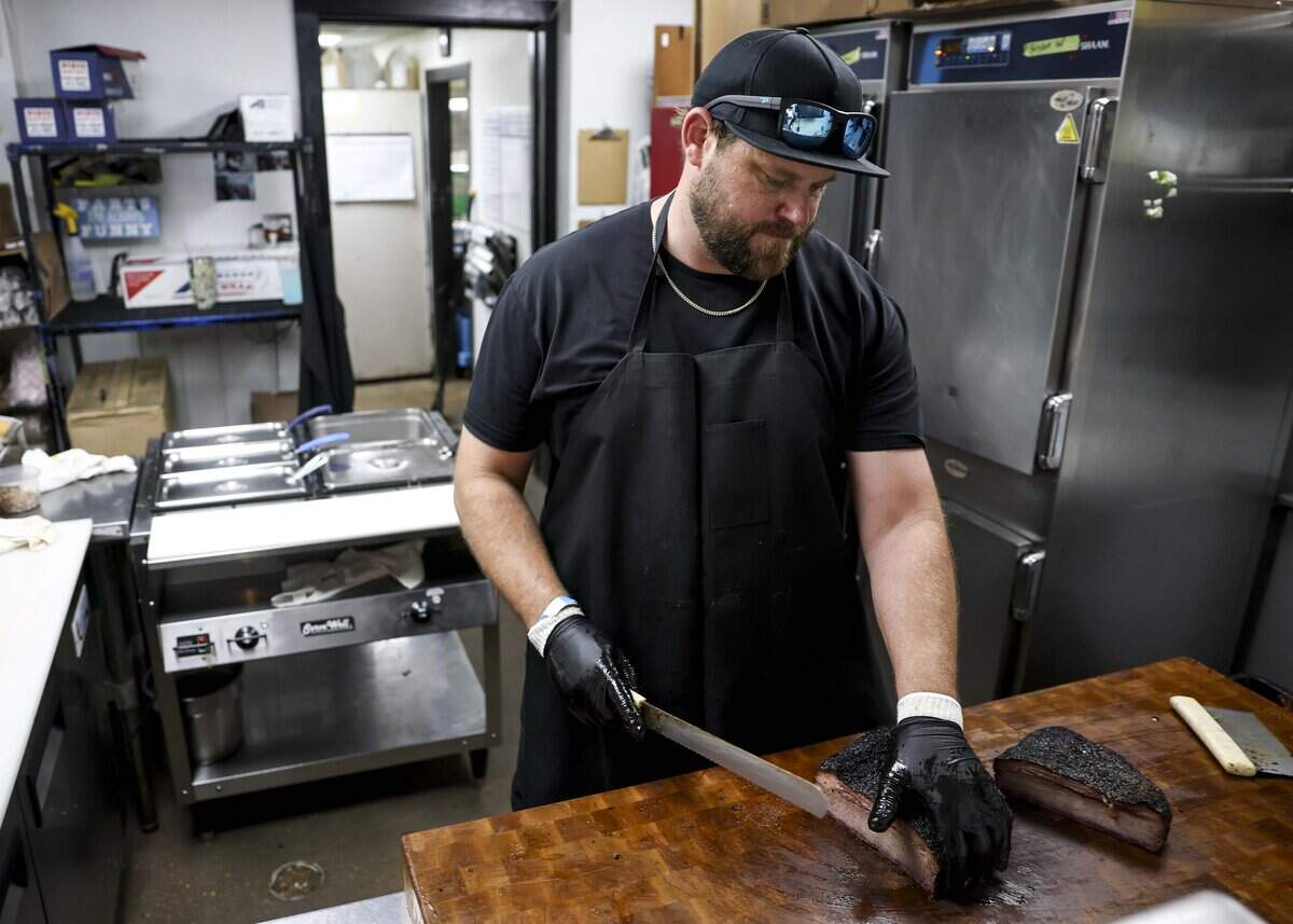 Dayne Weaver, owner of Dayne's Craft Barbecue, slices up brisket on Saturday, Aug. 15, 2026, in Aledo.