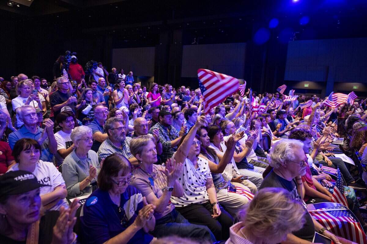 People wave American flags during James Talarico's The New American Dream Tour on Wednesday, Aug. 5, 2026 at Esports Stadium in Arlington, Texas.