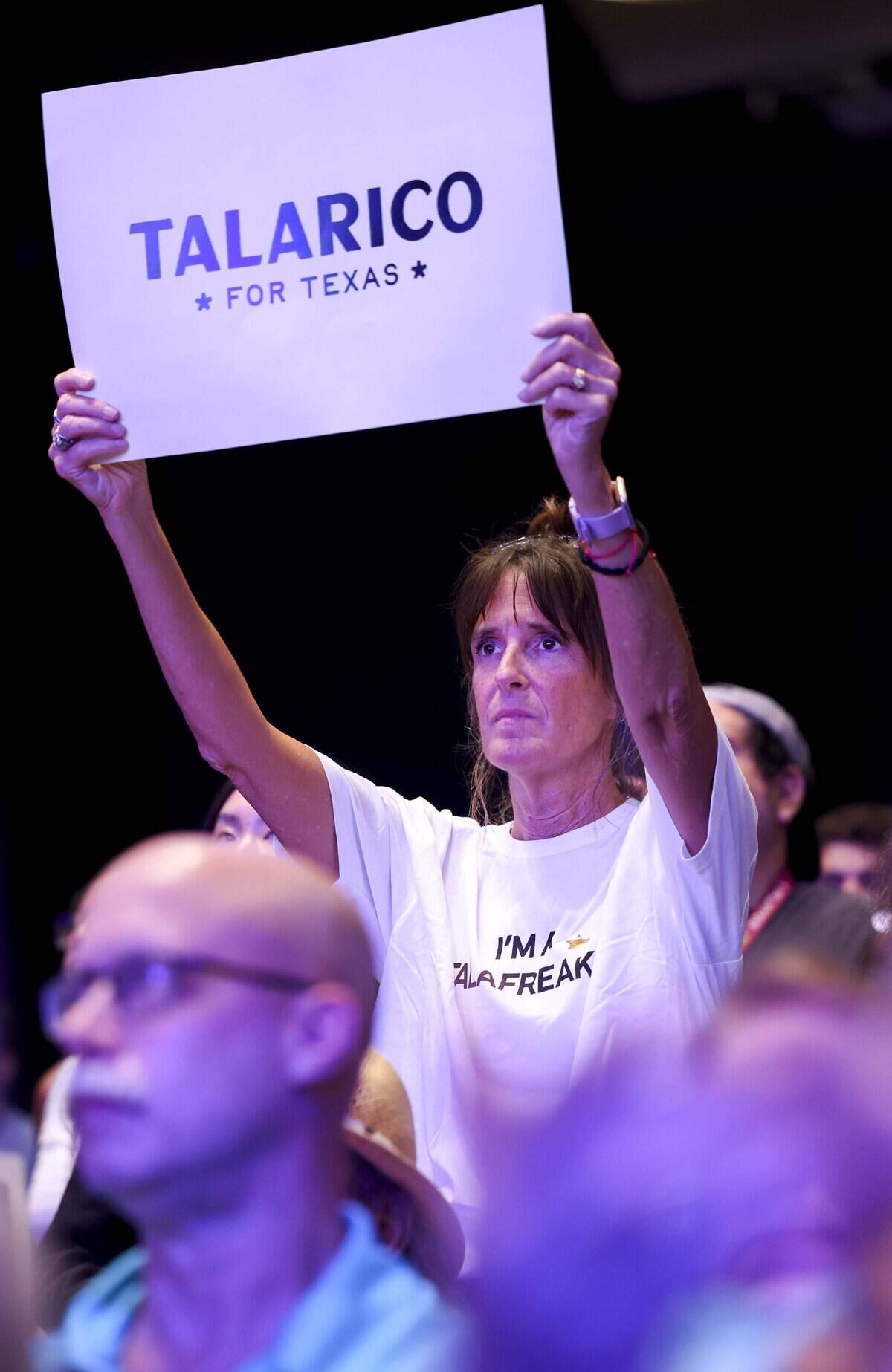 Cheryl Torress of Euless holds a sign in support of James Talarico, Texas' Democratic nominee for the U.S. Senate, during The New American Dream Tour on Wednesday, Aug. 5, 2026 at Esports Stadium in Arlington, Texas.