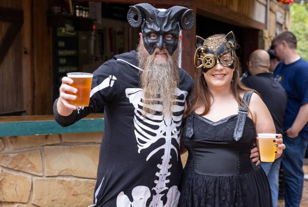 Image shows two costumed guests posing for a photo at Scarborough's Hollow. 
