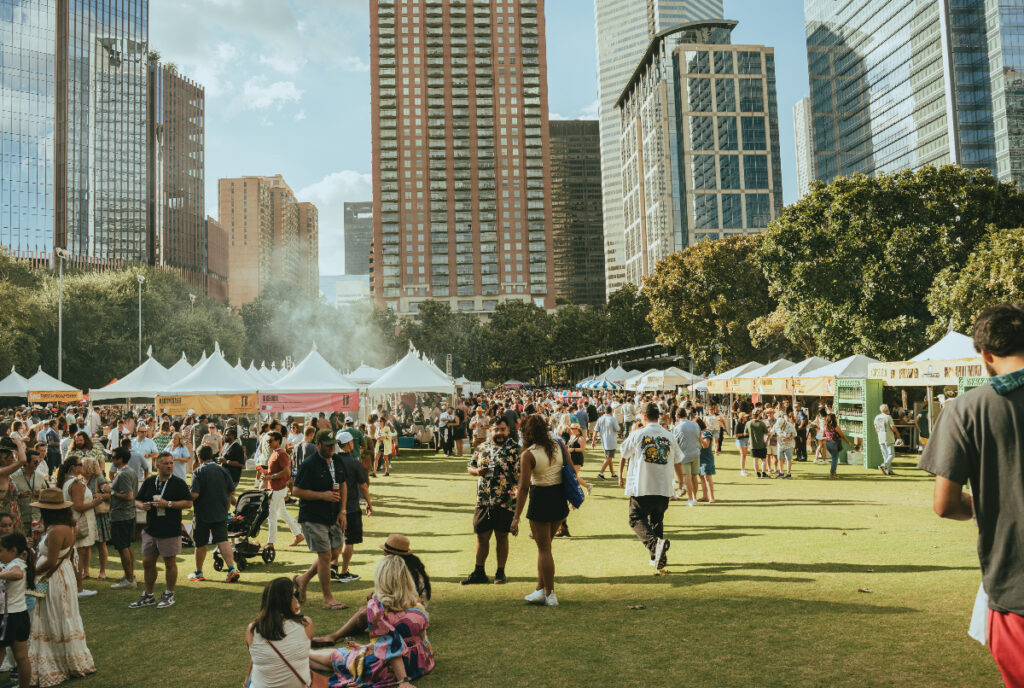 Image shows patrons at the Southern Smoke Festival in Houston with the city skyline in the background.