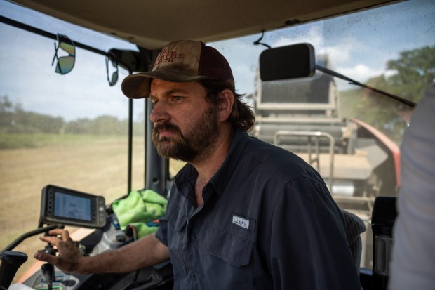 Patrick Williams harvests hay in Centerville, Texas. He and his brother Stephen are concerned about the environmental and economic impacts data centers will have on the area. (Antranik Tavitian/For The Washington Post)
