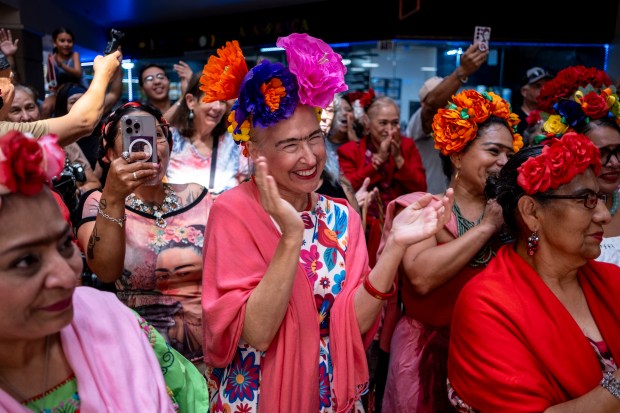 SAN ANTONIO, TEXAS - AUGUST 15: Susan Peavy applauds as she participates in a Guinness World Record attempt for the largest gathering of people dressed as Frida Kahlo during the 10th annual San Antonio Frida Fest on August 15, 2026 in San Antonio, Texas. Organizers counted 80 Kahlo look-alikes, not enough to surpass the 2017 largest recorded gathering of over 1,000 participants at the Dallas Museum of Art. (Photo by Joel Angel Juarez/Getty Images)