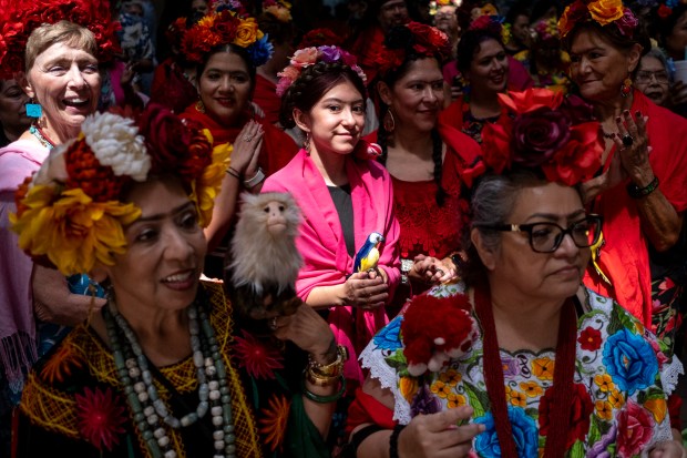 SAN ANTONIO, TEXAS - AUGUST 15: Moxie Guadiano, 12, participates in a Guinness World Record attempt for the largest gathering of people dressed as Frida Kahlo during the 10th annual San Antonio Frida Fest on August 15, 2026 in San Antonio, Texas. Organizers counted 80 Kahlo look-alikes, not enough to surpass the 2017 largest recorded gathering of over 1,000 participants at the Dallas Museum of Art. (Photo by Joel Angel Juarez/Getty Images)