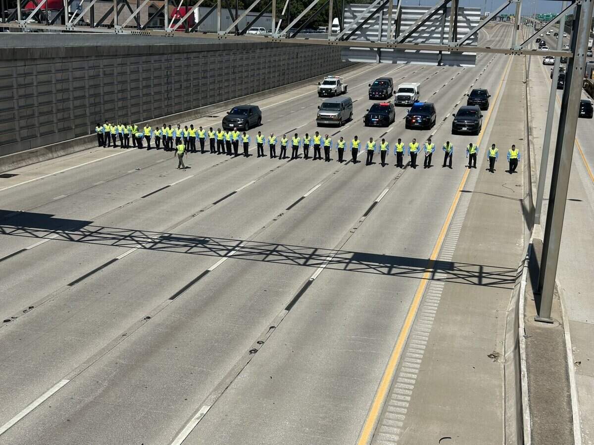 Fort Worth police cadets line up to search for evidence after an Everman ISD teacher’s aide was killed in a road rage shooting in the eastbound lanes of I-20 on Thursday morning, Aug. 13, 2026.