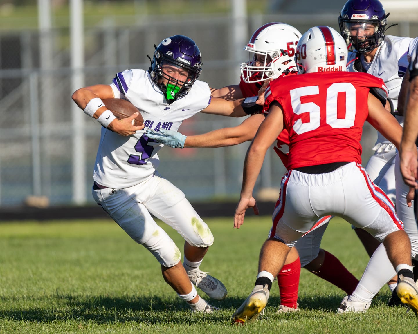 Ryder Knapp (5) of Plano runs ball as Jacen Guerrero (52) of Ottawa attempts to tackle him on Saturday, August 22, 2026 at King Field in Ottawa.
