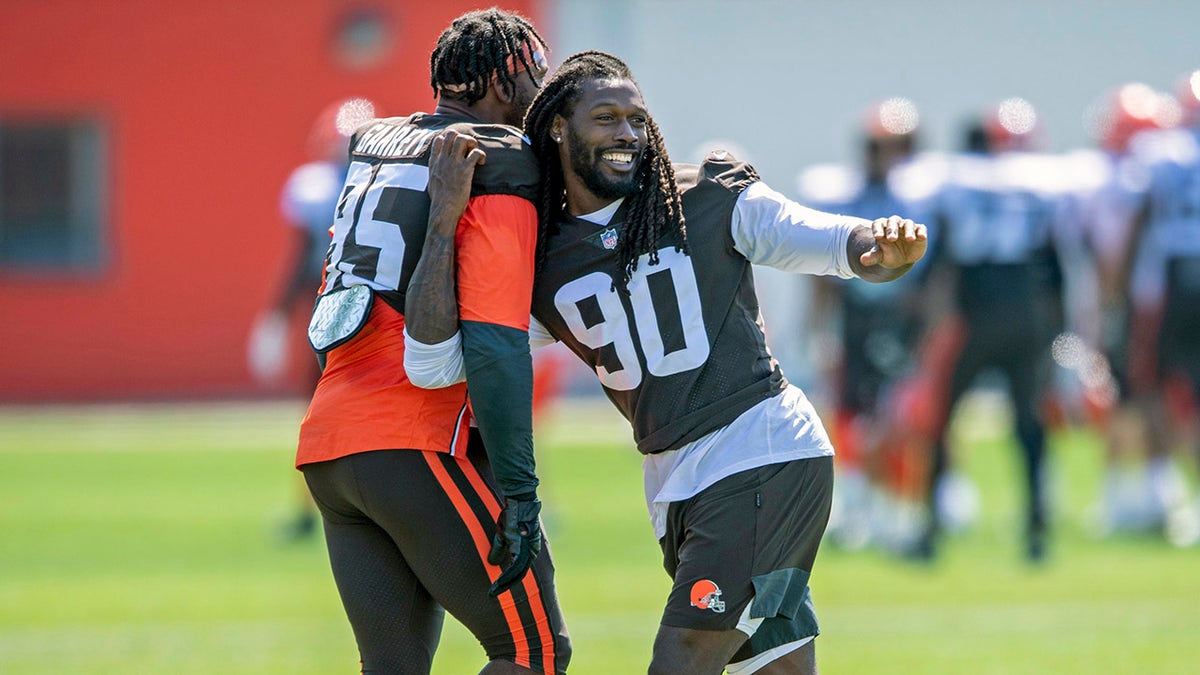 Cleveland Browns defensive linemen Jadeveon Clowney, right, goofs around with defensive linemen Myles Garrett (95) during an NFL football practice in Berea, Ohio, Wednesday, Aug. 4, 2021. (AP Photo/David Dermer)