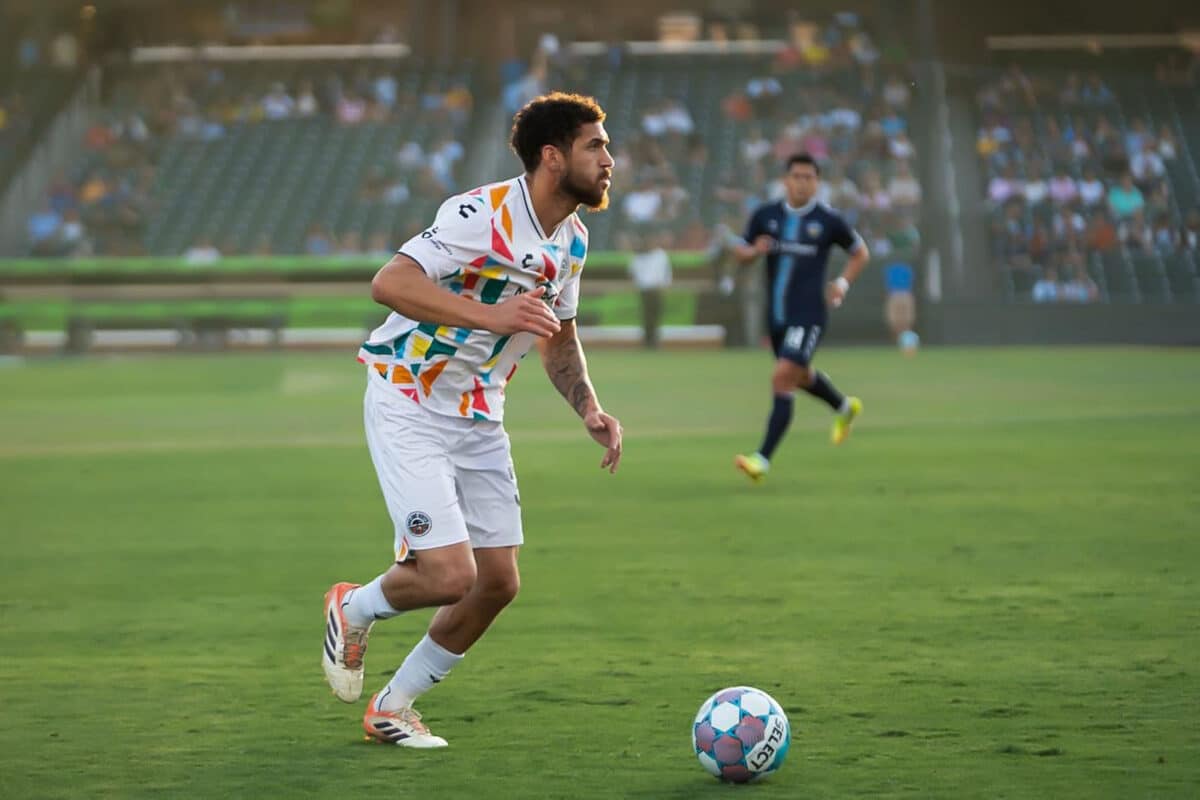 Alameda Post - An Oakland Roots player dribbles the ball in a match against El Paso Locomotive.